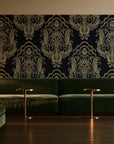 Sunlit Thicket Noir damask wallpaper in an intimate luxury cocktail lounge