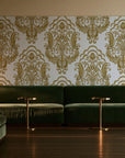 Sunlit Thicket Ochre damask wallpaper in an intimate luxury cocktail lounge