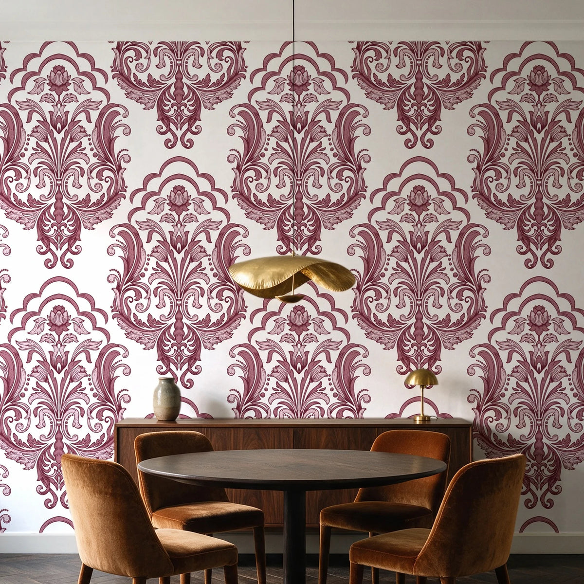 Sunlit Thicket Oxblood damask wallpaper behind a walnut credenza and round table in an elegant dining room