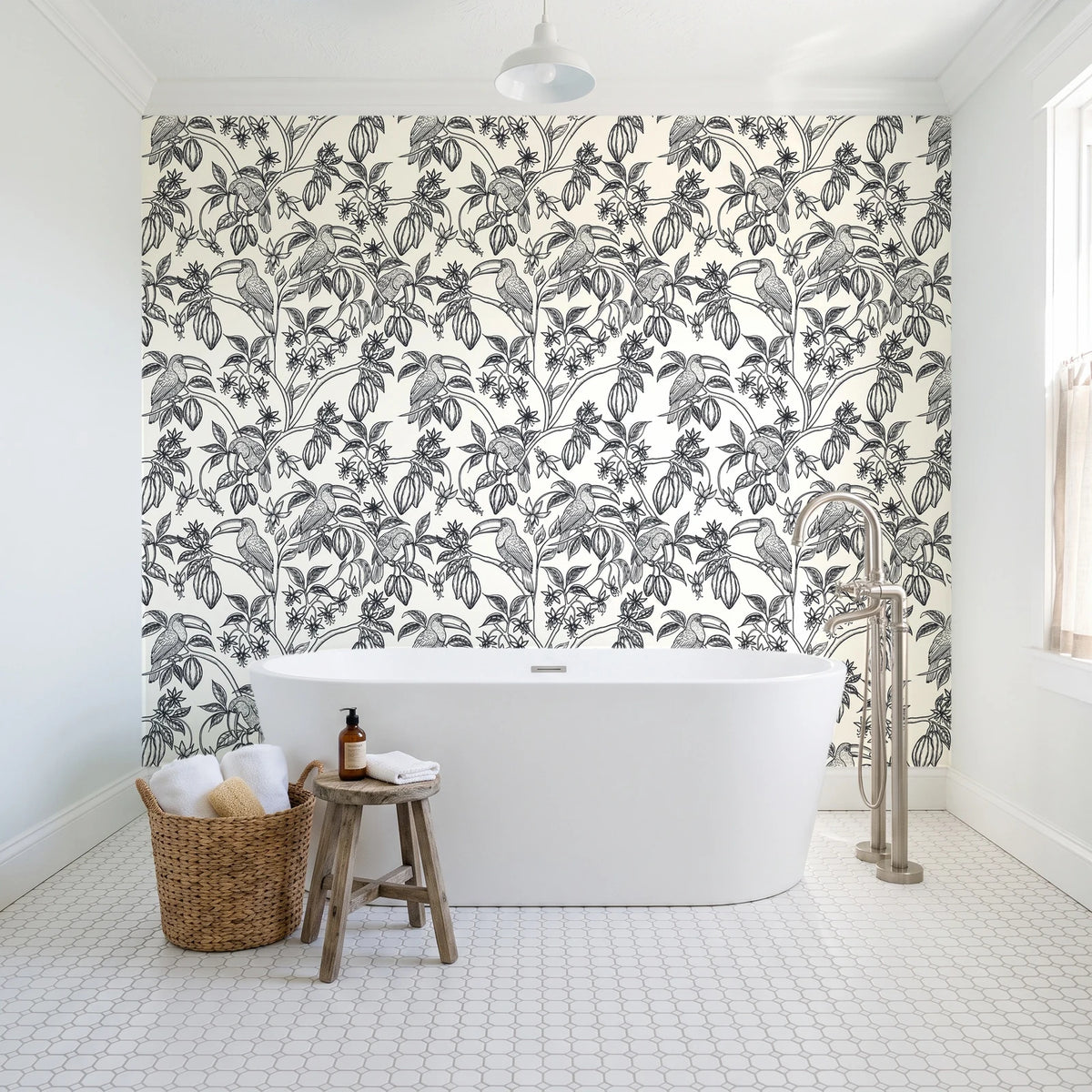 Toucan Toile Ink tropical bird wallpaper behind a freestanding tub in a bright coastal bathroom