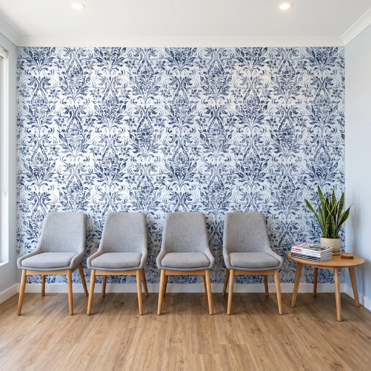 Tranquil Flora Indigo floral damask wallpaper behind a row of upholstered chairs in a bright clinic waiting room