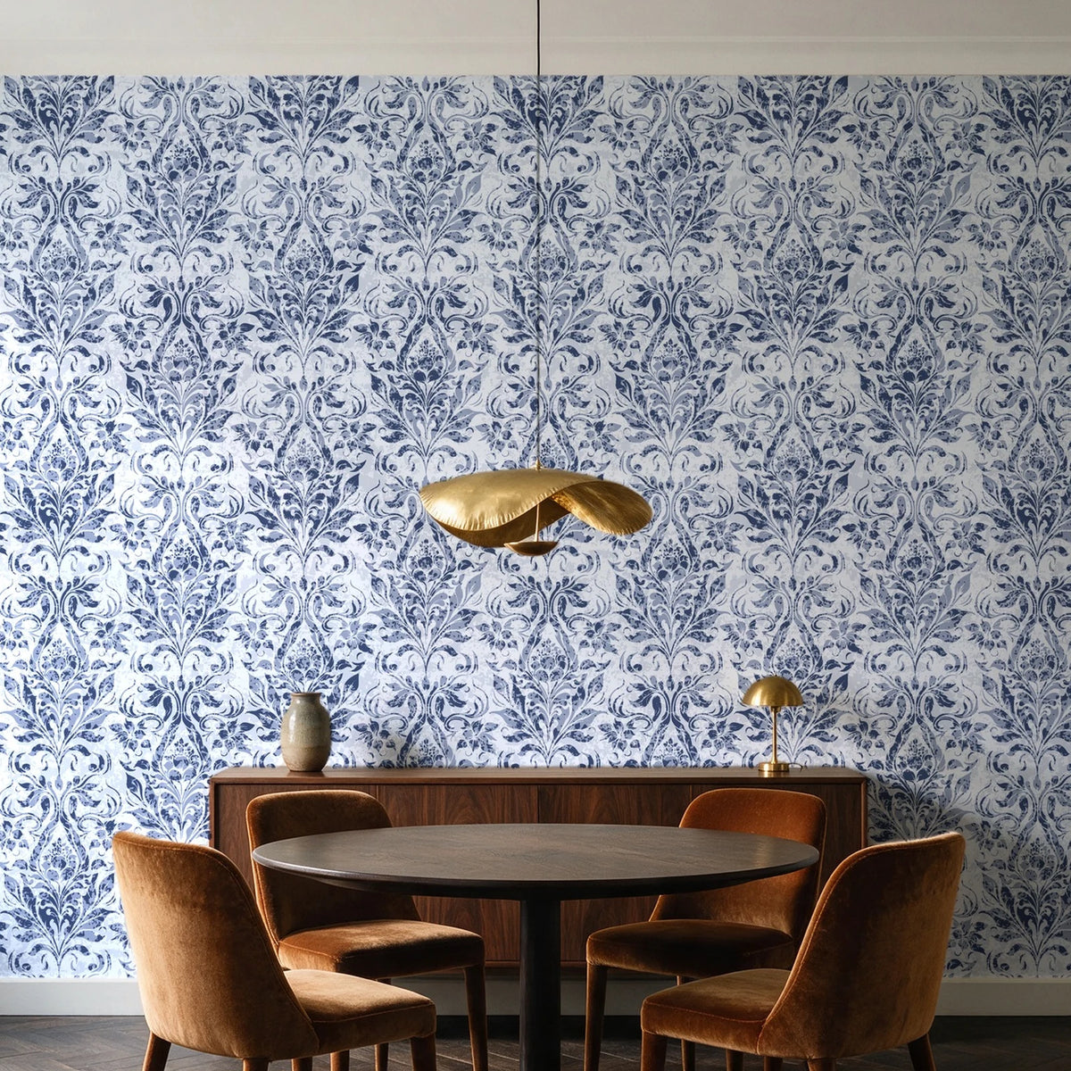 Tranquil Flora Indigo floral damask wallpaper behind a walnut credenza and round table in an elegant dining room