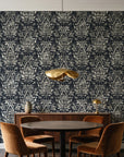 Tranquil Flora Onyx floral damask wallpaper behind a walnut credenza and round table in an elegant dining room