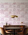 Tranquil Flora Rose floral damask wallpaper behind a walnut credenza and round table in an elegant dining room