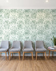 Tranquil Flora Sage floral damask wallpaper behind a row of upholstered chairs in a bright clinic waiting room