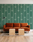 Tranquility Tapestry Emerald art deco stripe wallpaper behind a rust velvet sofa in a bright coworking lounge