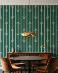 Tranquility Tapestry Emerald art deco stripe wallpaper behind a walnut credenza and round table in an elegant dining room