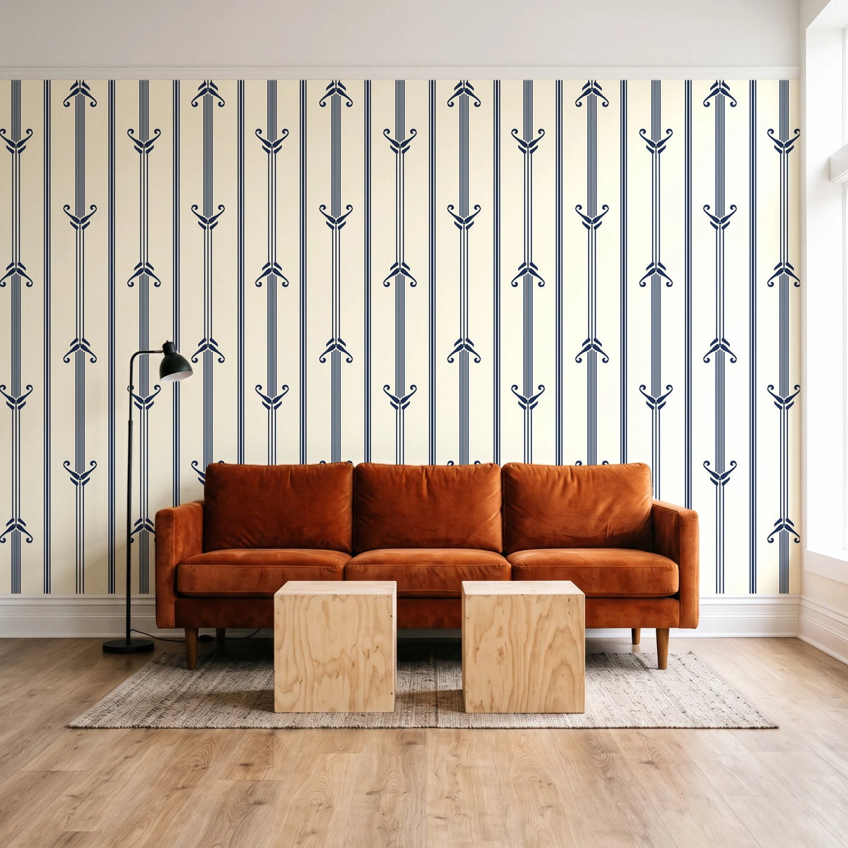 Tranquility Tapestry Midnight art deco stripe wallpaper behind a rust velvet sofa in a bright coworking lounge
