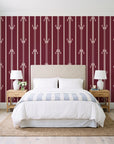 Tranquility Tapestry Oxblood art deco stripe wallpaper behind a queen bed in a bright coastal bedroom