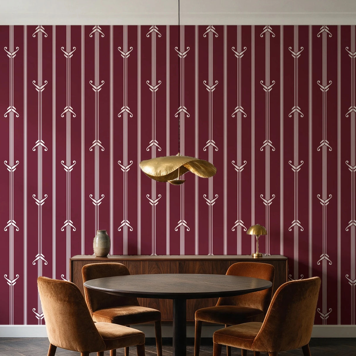 Tranquility Tapestry Oxblood art deco stripe wallpaper behind a walnut credenza and round table in an elegant dining room