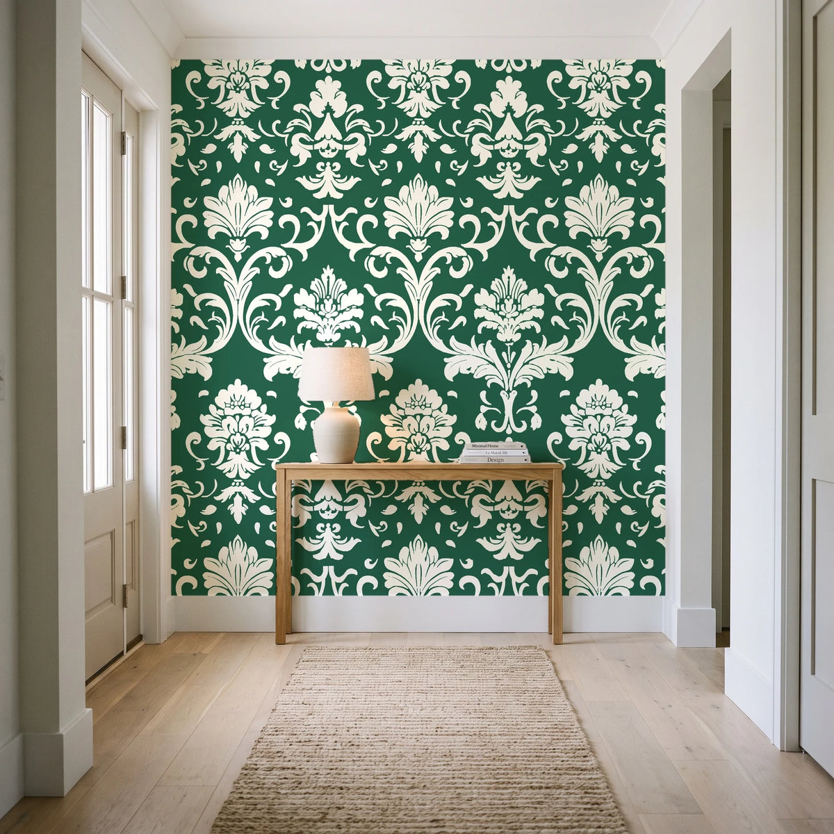Twilight Garden Veil Emerald damask wallpaper behind a console table in a light entry hallway