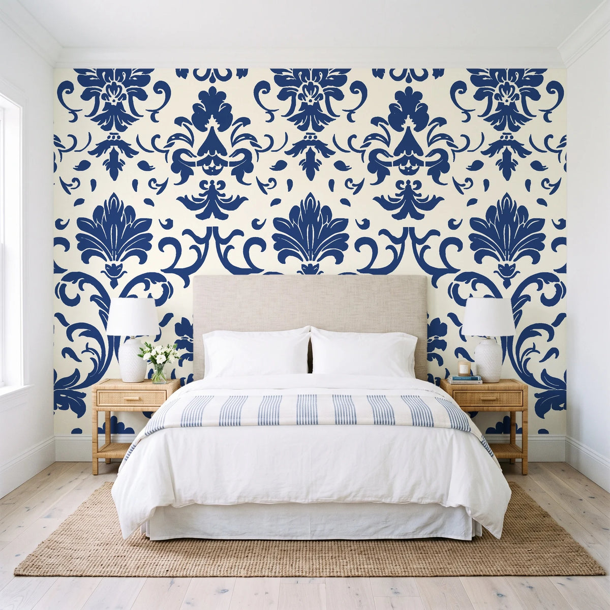 Twilight Garden Veil Indigo damask wallpaper behind a queen bed in a bright coastal bedroom