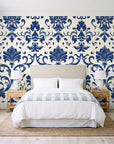 Twilight Garden Veil Indigo damask wallpaper behind a queen bed in a bright coastal bedroom