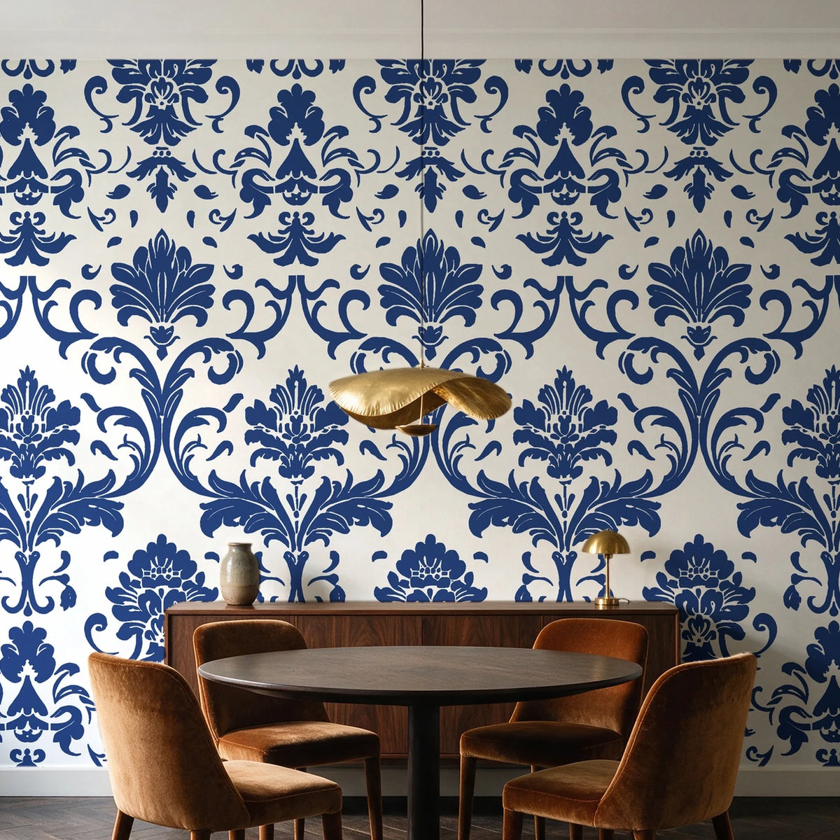 Twilight Garden Veil Indigo damask wallpaper behind a walnut credenza and round table in an elegant dining room