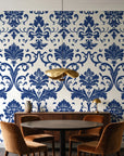 Twilight Garden Veil Indigo damask wallpaper behind a walnut credenza and round table in an elegant dining room