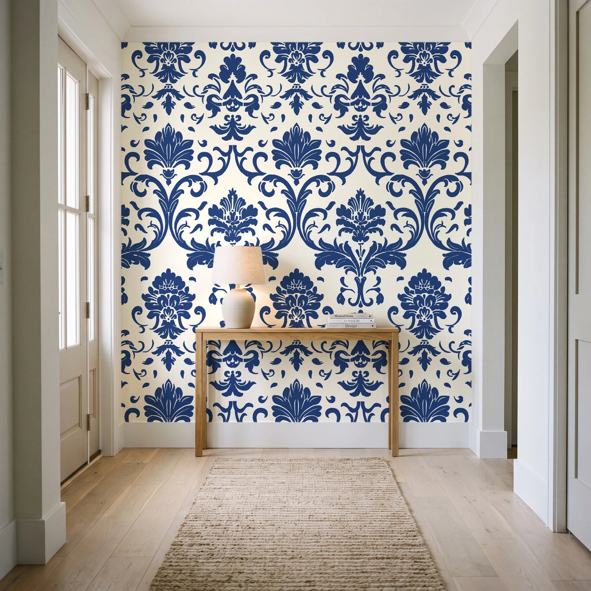 Twilight Garden Veil Indigo damask wallpaper behind a console table in a light entry hallway