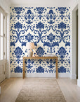 Twilight Garden Veil Indigo damask wallpaper behind a console table in a light entry hallway