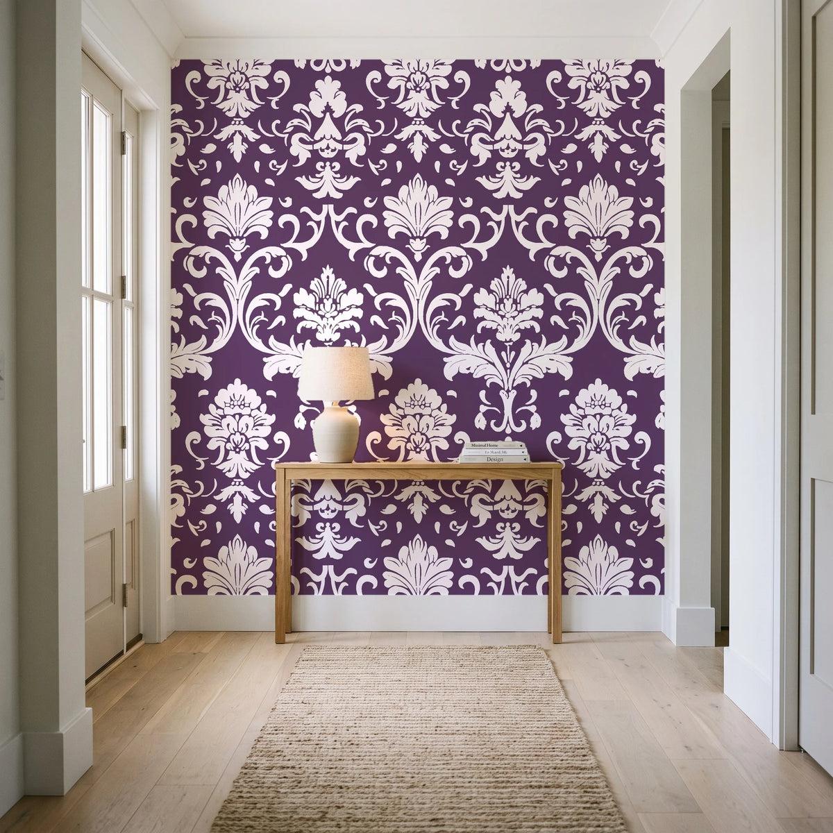 Twilight Garden Veil Plum damask wallpaper behind a console table in a light entry hallway