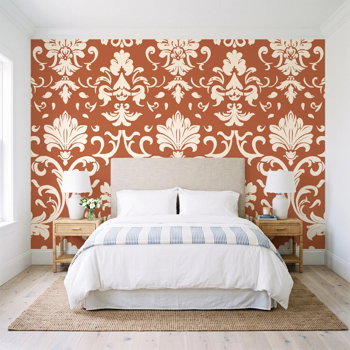 Twilight Garden Veil Terracotta damask wallpaper behind a queen bed in a bright coastal bedroom
