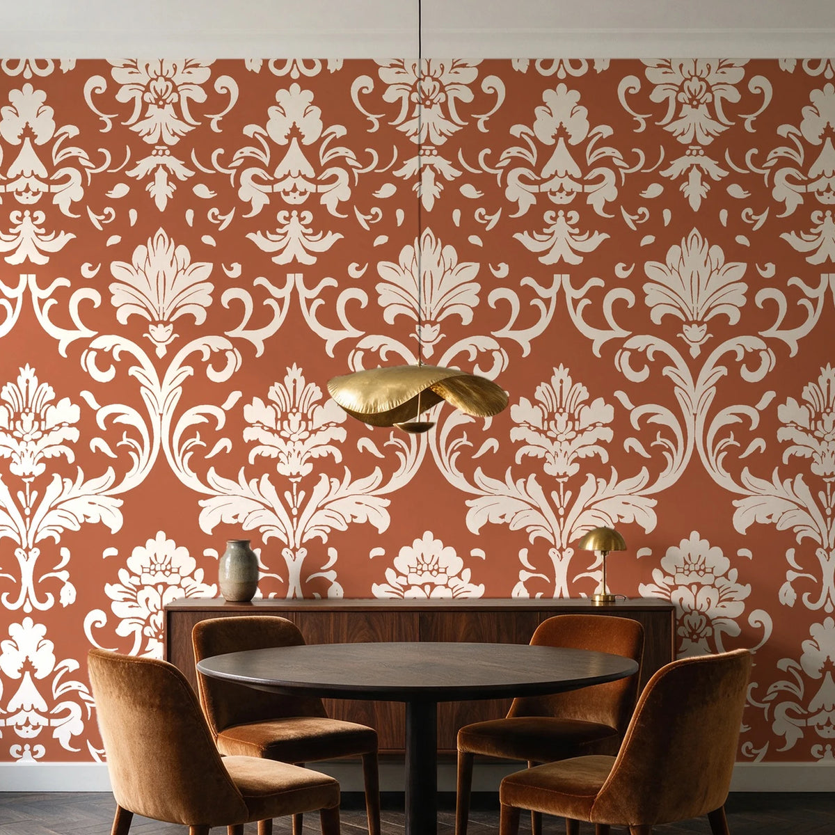 Twilight Garden Veil Terracotta damask wallpaper behind a walnut credenza and round table in an elegant dining room