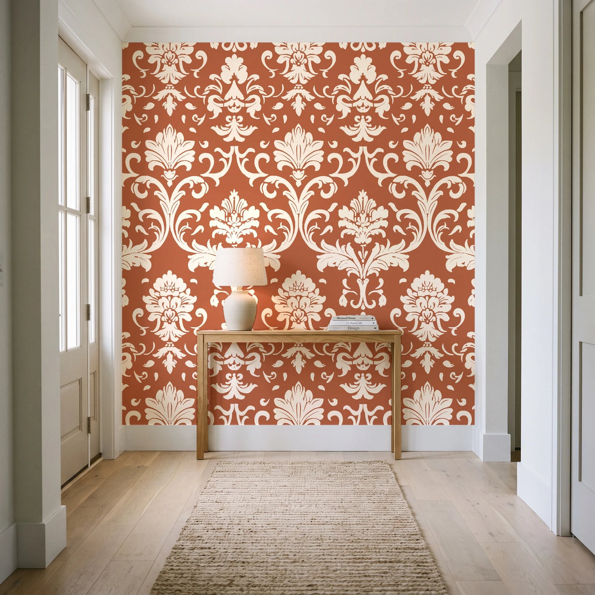 Twilight Garden Veil Terracotta damask wallpaper behind a console table in a light entry hallway