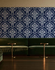 Veiled Botany Navy damask wallpaper in an intimate luxury cocktail lounge