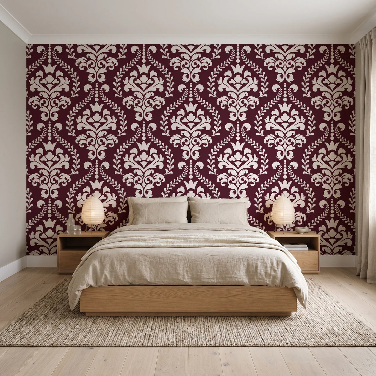 Veiled Botany Oxblood damask wallpaper behind a low platform bed in a serene Japandi bedroom