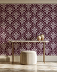 Veiled Botany Oxblood damask wallpaper on the wall of a grand entry foyer