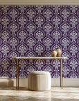 Veiled Botany Plum damask wallpaper on the wall of a grand entry foyer