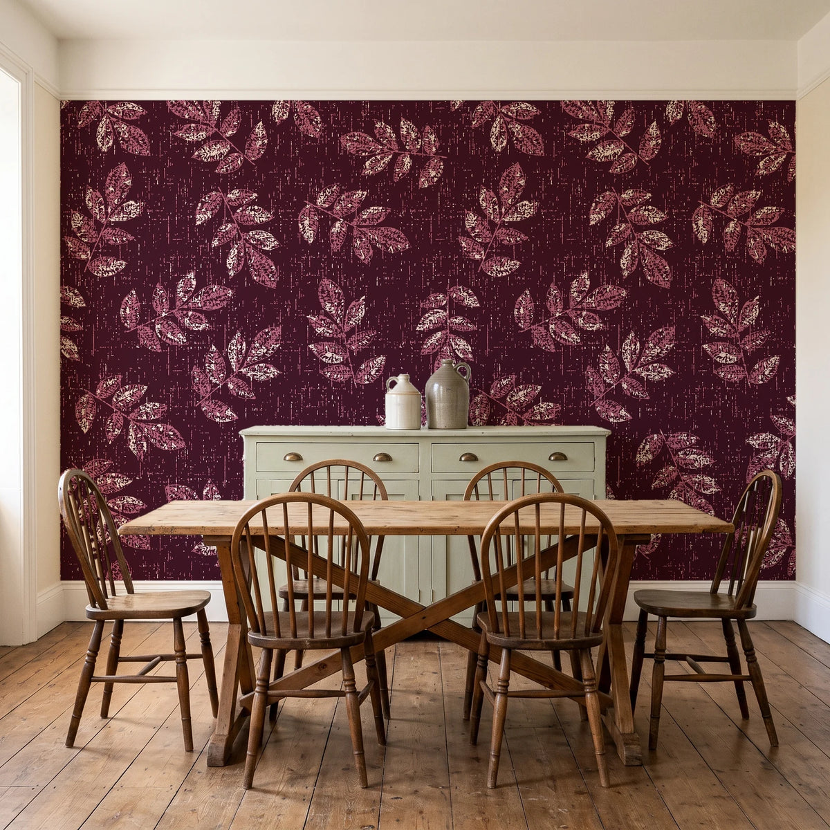 Verdant Scatter Oxblood tossed leaf wallpaper in a farmhouse dining room with a sage sideboard and rustic trestle table