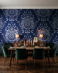 Vintage Eden Midnight damask wallpaper in a dark moody dining room with a candlelit table