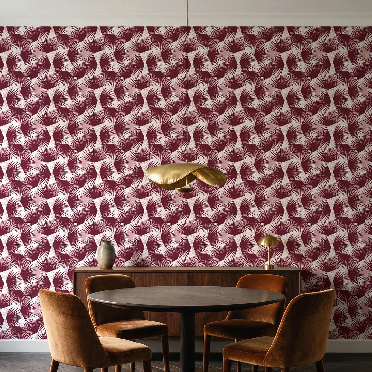 Wild Palm Oxblood palm wallpaper behind a walnut credenza and round table in an elegant dining room