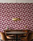 Wild Palm Oxblood palm wallpaper behind a walnut credenza and round table in an elegant dining room
