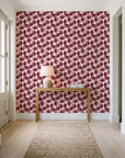 Wild Palm Oxblood palm wallpaper behind a console table in a light entry hallway
