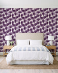 Wild Palm Plum palm wallpaper behind a queen bed in a bright coastal bedroom