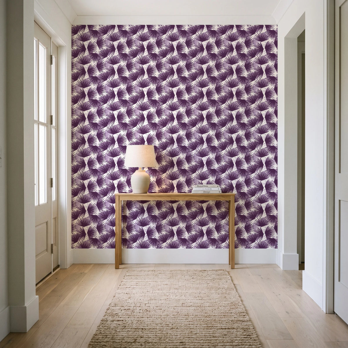 Wild Palm Plum palm wallpaper behind a console table in a light entry hallway