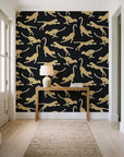 Wild Stride Noir cheetah wallpaper behind a console table in a light entry hallway