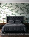 Wild Stride Sage cheetah wallpaper behind a tufted headboard in a dark, moody bedroom