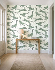 Wild Stride Sage cheetah wallpaper behind a console table in a light entry hallway