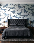 Wild Stride Slate cheetah wallpaper behind a tufted headboard in a dark, moody bedroom