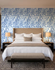 Willow Trace Indigo willow vine wallpaper behind the headboard of a king bed in a contemporary hotel guest room
