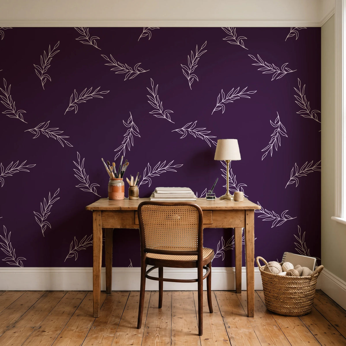 Willow Whisper Aubergine willow sprig wallpaper behind a vintage writing desk in a cozy craft-room home office