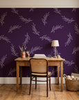 Willow Whisper Aubergine willow sprig wallpaper behind a vintage writing desk in a cozy craft-room home office