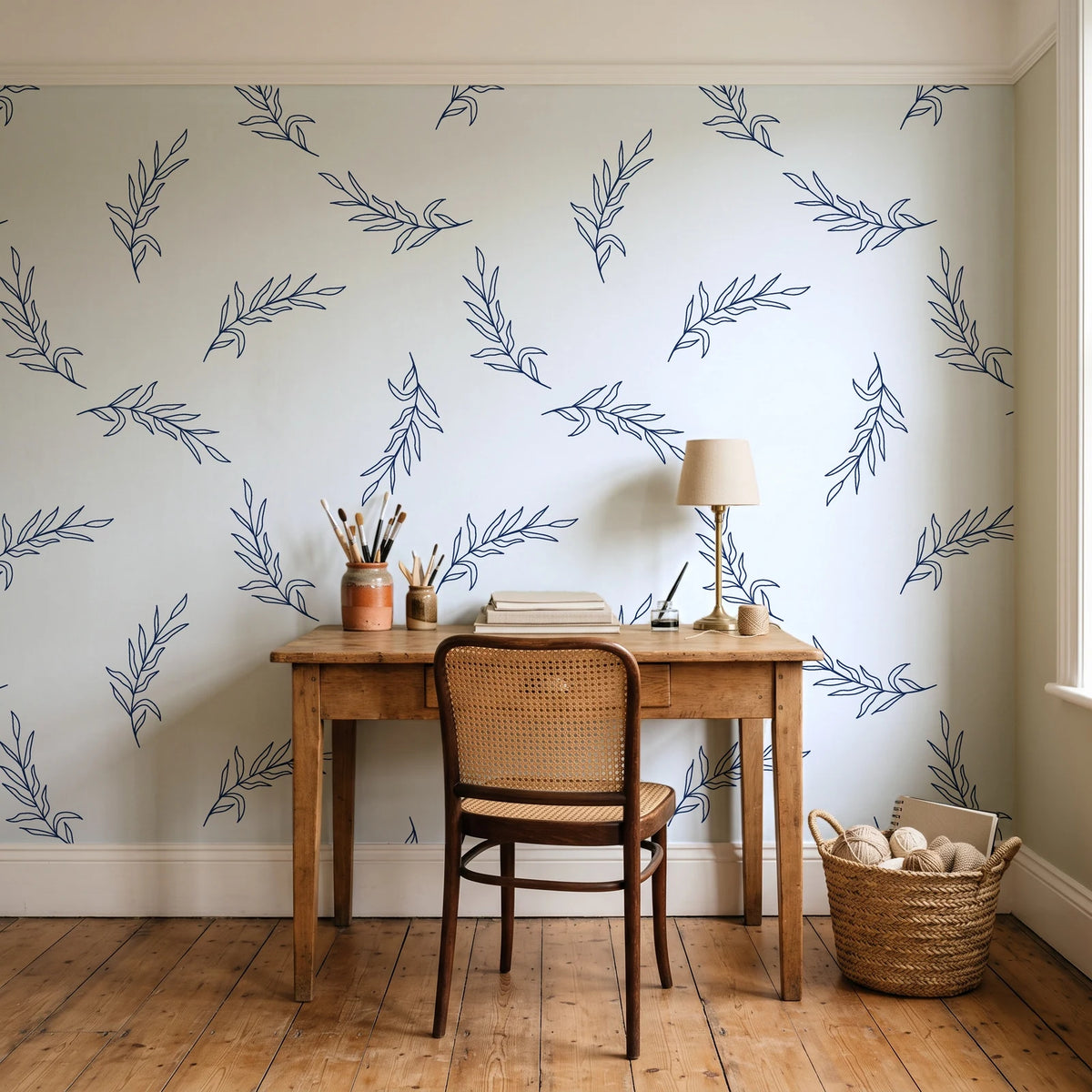 Willow Whisper Navy willow sprig wallpaper behind a vintage writing desk in a cozy craft-room home office