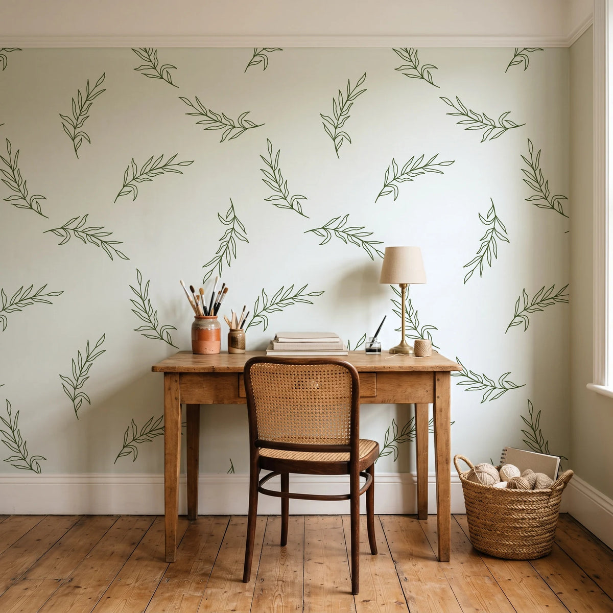 Willow Whisper Olive willow sprig wallpaper behind a vintage writing desk in a cozy craft-room home office