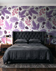 Winter Forage Plum pine bough and berry wallpaper behind a tufted headboard in a dark, moody bedroom