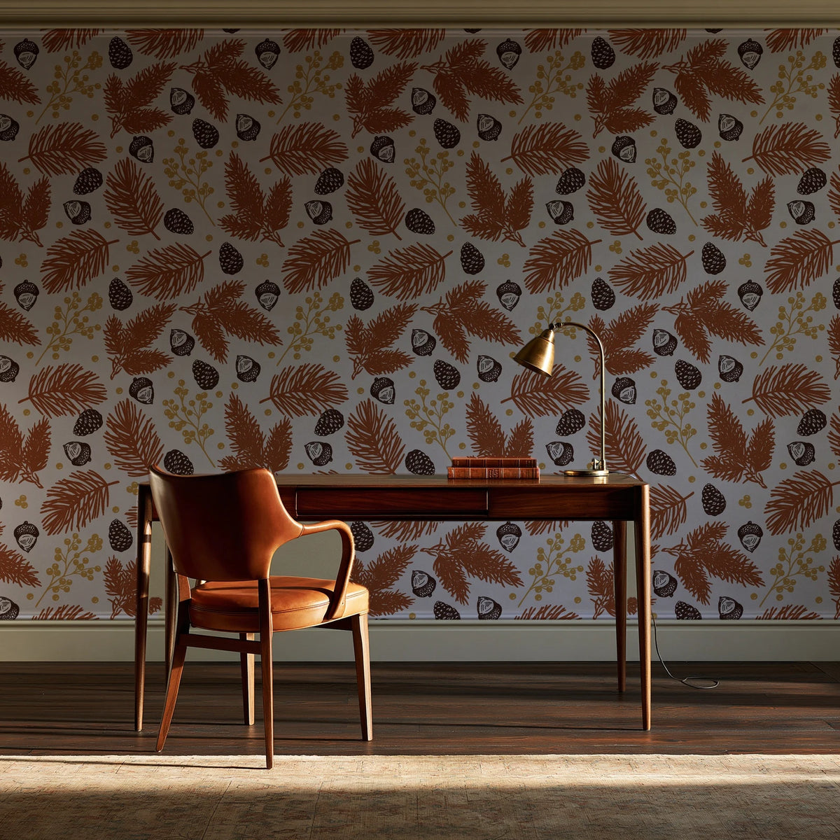 Winter Forage Terracotta pine bough and berry wallpaper as a feature wall in a home study