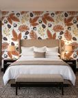 Winter Forage Terracotta pine bough and berry wallpaper behind the headboard of a king bed in a contemporary hotel guest room