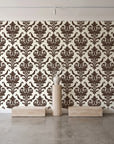 Woodland Blossom Veil Espresso damask wallpaper behind a travertine pedestal and vase in a minimal boutique