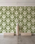 Woodland Blossom Veil Olive damask wallpaper behind a travertine pedestal and vase in a minimal boutique